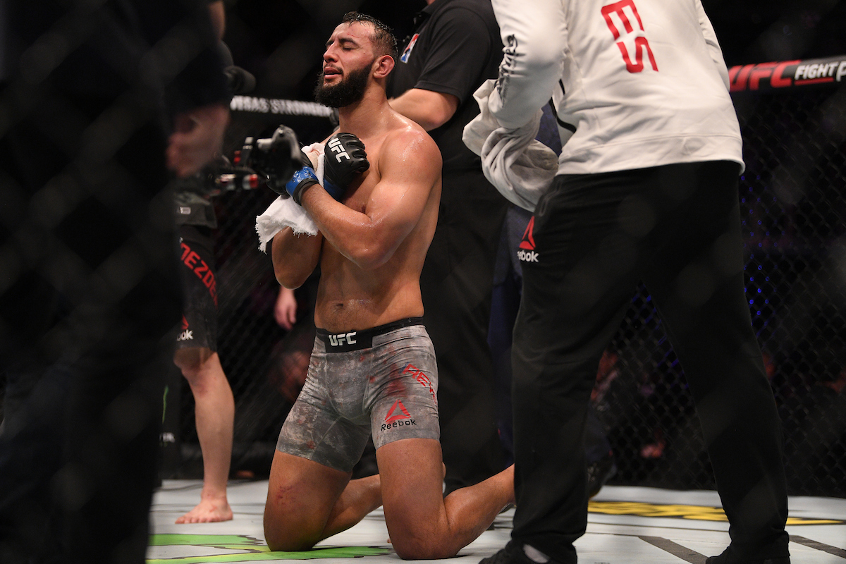 Dominick Reyes se ajoelha no octógono do UFC Londres.