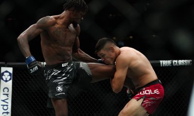 Vicente Luque buscando o single leg sobre Kevin Holland no UFC 316