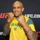 Sorridente, Charles Oliveira posa para foto no media day do UFC 326